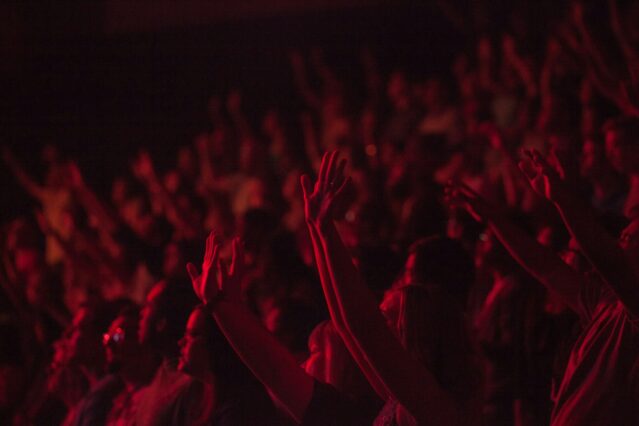 crowd of people lit up in red