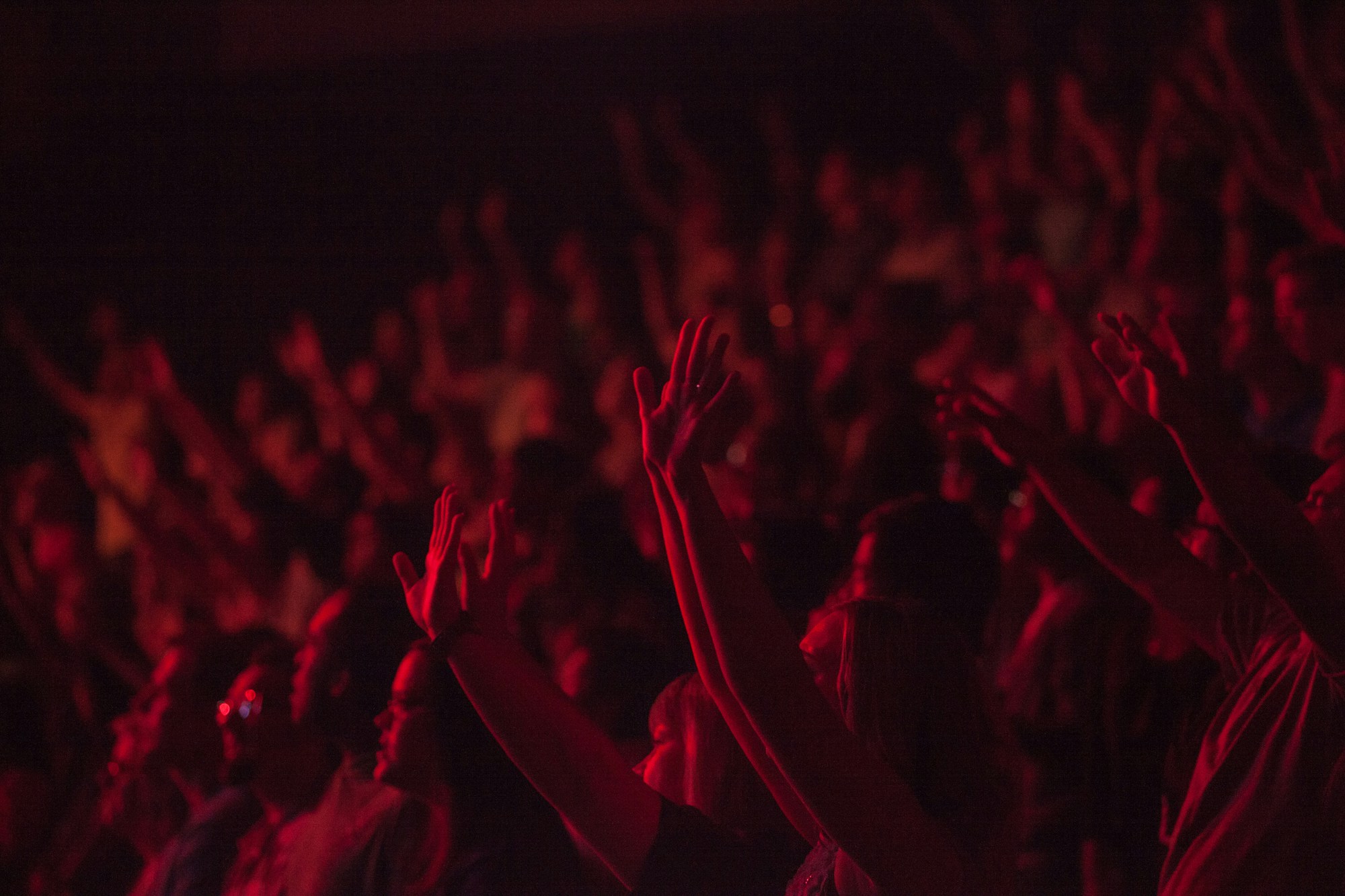 crowd of people lit up in red