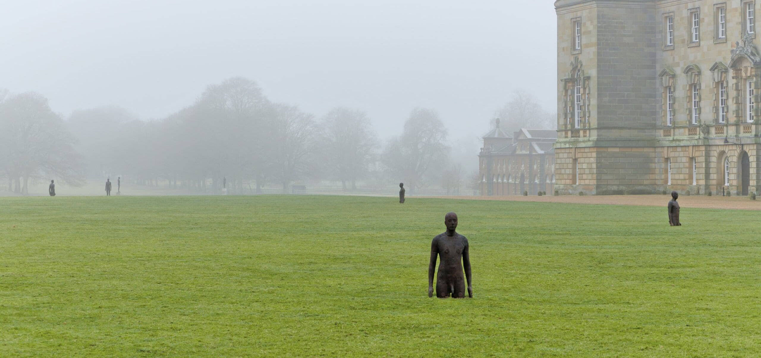 Antony Gormley sculpture in grass on Houghton Hall grounds